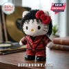 Hello Kitty plush doll dressed as Michael Jackson with a red leather jacket, curly black hair, and a red bow on wood desk.!