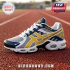 University of Michigan men's basketball champion sneaker in navy, maize, and grey on a red running track.!