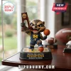 Rocket Raccoon figurine in a Michigan Wolverines basketball uniform holding an NCAA 2026 Champions trophy on a base.!