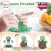 Hands crocheting green yarn next to a basket of yarn balls and three views of a small turtle amigurumi toy with a sign.!