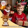 Brown crocheted highland cow toy holding a sign that reads Positive Moo with motivational text against a holiday backdrop.!
