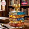 Stack of colored glass books shaped decanter with a matching book-shaped glass stopper on a leather desk mat.!