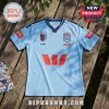 Light blue NSW Blues rugby league jersey with Ampol, Westpac, and GIO sponsor logos on a wooden outdoor surface.!