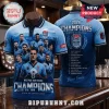 Light blue NSW Blues 2026 Champions polo shirt featuring team player graphics, squad roster list, and State of Origin logos.!