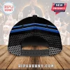 Back view of a black baseball cap with blue stripes and grey dot patterns, featuring an adjustable plastic snapback closure.!