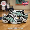 New York Liberty themed sneakers with black, white, and seafoam green mesh upper on a hardwood basketball court background.!