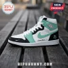 Custom Air Jordan high-top sneaker in white, black, and mint green leather sitting on a wooden bench.!