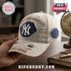 New York Yankees 1903-2026 Distressed Beige Baseball Cap featuring blue pinstripe patches and embroidered team text.