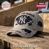 New York Yankees 1903-2026 Embroidered Distressed Cap in grey and navy with heavy fabric fraying on a wood surface.