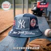 New York Yankees distressed denim bucket hat with white logo, frayed seams, and baseball team patches on a wood bench.