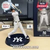 New York Yankees MLB Sculpted Player Figurine in pinstripe uniform swinging a bat on a circular team-branded display base.
