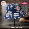 New York Yankees navy blue bucket hat with white repeating team logos, text, and baseball motifs on a metal stand.