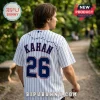 Man wearing a white pinstripe baseball jersey with KAHAN 26 in blue text and a small spider graphic on the back.!
