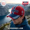 Red and blue Norway 2026 embroidered baseball cap with white geometric trim and compass icon worn outdoors.!