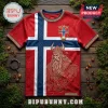 Norway flag themed red jersey with gold Viking portrait, Nordic knotwork patterns, and NORGE crest on wooden surface.!