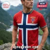 Man wearing red shirt with embossed Norway flag, Norse knotwork, and viking ship design against a mountain background.!