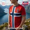 Man wearing red jersey with Norway flag design, Norse knotwork, Viking ship motif, and Norge crest over mountain landscape.!