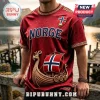 Maroon Viking-themed t-shirt featuring a Norse ship, Norwegian flag shield, and gold Celtic knot trim on a blurred dock.!