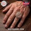 Rose gold tone Pantera heavy metal band championship ring with skull emblem and iridescent center stone on a hand.!
