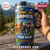 Blue stainless steel tumbler with block-style character graphics, gaming icons, and placeholder text YOUR NAME.!