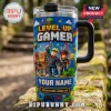 Stainless steel tumbler with blocky gaming characters, text reading LEVEL UP GAMER and ADVENTURE MODE ON, with lid handle.!