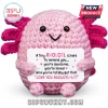 Pink crochet axolotl plush holding a sign with positive affirmations on a white background.!