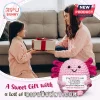 Pink crochet axolotl plush holding a white sign with text messages about love and support near a mother and daughter.!