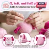 Hands crocheting a pink yarn axolotl with dark pink gills, featuring a small sign held by the stuffed animal.!