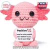 Pink crochet axolotl plush holding a sign that reads Positive I may be a tiny axolotl but I believe in you.!