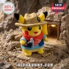 Yellow Pikachu plush wearing a brown explorer hat, blue jacket, and red scarf while holding a toy pickaxe in a cave.!