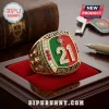 Gold championship ring featuring Portugal flag enamel, number 21, and Diogo Jota text resting on a red velvet display box.!