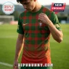 Man wearing a green and red plaid Portugal national soccer jersey with a gold Nike swoosh and team crest on a field.!