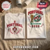 Two white cotton t-shirts featuring Portugal soccer graphics, World Cup trophy, and 2026 text on a linen background.!