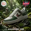 Predator-themed sneaker with white leather, green reptilian-textured panels, metallic swoosh, and red targeting lights.!