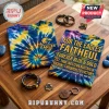 Premium West Coast Eagles Tie Dye T-Shirt with blue and yellow spiral patterns and team text on a wooden table.