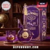 Prince themed Jack Daniel’s guitar-shaped purple glass decanter and matching whiskey glass on a wooden table.!