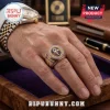 Gold Prince memorial ring with purple inlay and glyph symbol worn on a man's finger, two-tone watch in the background.!