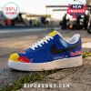Blue sneaker with Oracle Red Bull Racing branding, yellow toe box, black swoosh, and Ford logo on a track background.!