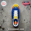 Ford and Red Bull branded sneakers featuring a blue, yellow, and red color scheme with white laces on a concrete floor.!