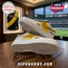 Richmond Tigers themed leather sneakers with yellow side panels, black swoosh, and team tiger logo on white background.!