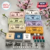 Route 66 board game set featuring colored play money, dice, red and green house tokens, and metal car and diner figurines.!