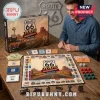 Route 66 100th Anniversary Monopoly game board, cards, paper money, and silver tokens on a wooden table.!