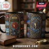 Rush Stained Glass Art Ceramic Mug featuring band album artwork in gothic window panels against a wooden desk background.