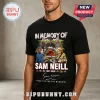 Black cotton t-shirt featuring a Jurassic Park graphic, Sam Neill portraits, dates 1947-2026, and signature print.!
