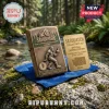 Antique brass Sasquatch metal lighter and collector card on a blue velvet cloth atop a mossy rock in a forest setting.!