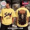 Yellow t-shirt with SAW movie logo, Billy the Puppet, gears, red spirals, and text Every choice has a cost.!
