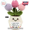 Crochet tulip plant in a cream pot with a happy face holding a sign reading It doesn't matter how old I get I need you.!