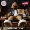 Crochet Snoop Dogg doll wearing a blue plaid shirt and sneakers, holding a sign reading Emotional Support Snoop.!