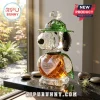 Snoopy crystal figurine wearing a green hat with 1950-2025 75th anniversary text on an amber heart torso base.!