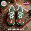 Snoopy Christmas themed athletic sneakers with green and red patterns, white laces, and graphic prints on a rug.!